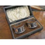 A Walker and Hall pair of silver napkin rings shaped borders Sheffield 1947 cased