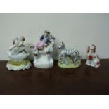 Five various Staffordshire figures, child riding a swan, boy on goat, zebra,