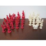 A 19th Century carved and stained part ivory Eastern Chess set, damage as shown,