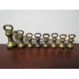 A set of eight bygone brass weights