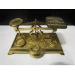 A late 19th/ early 20th Century set of brass postal scales scrolled foliate base,