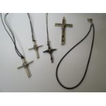 Four various white metal crosses,