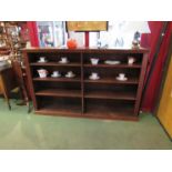 A large stained oak bookcase floor standing double width