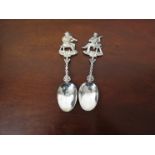 Two ornate silver spoons with musician terminals, import marks for Edwin Thompson Bryant,