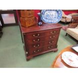 A George III mahogany chest of four graduating long drawers,