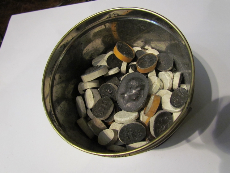 A tin containing tin seals on plaster bases