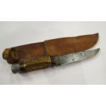 A mid 20th Century German hunting knife with sawback blade, antler handle and leather sheath, by L.