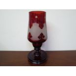 An Edwardian ruby glass vase with etched repeating pattern, 27.