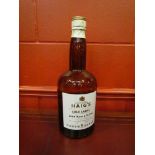 An oversize Haig brown glass whisky bottle