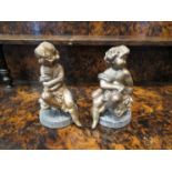 A 19th Century pair of seated figures on lead bases