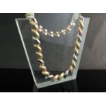 A three tone gold necklace brushed and polished gold links, stamped 14k ,