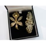 A white metal marcasite set floral brooch with simulated pearl,