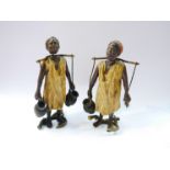 An early 20th Century pair of hand painted lead figures of African water carriers, nodding heads,