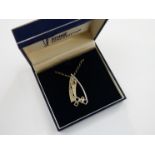 A white metal Rennie Mackintosh reproduction modernist pendant on chain, boxed,