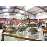 A Goldsmiths and Silversmiths company four piece teaset, London 1905, 1906 and 1907, treen handles,