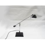 A black painted metal desk lamp with adjustable chrome plated metal arms