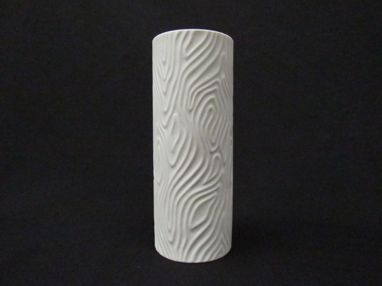 A late 1960's Heinrich matte white cylinder vase finished in a raised psychedelic swirl relief 21.