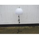 A painted and chromed metal standard lamp base with an opaque white perspex shade