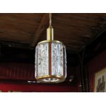 A Danish ceiling light pendant in textured clear glass with brassed and wood effect frame