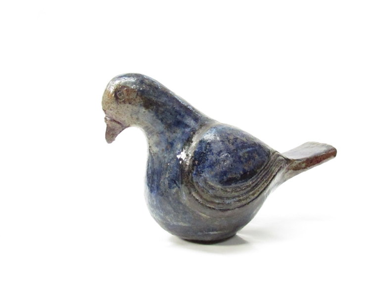 A Scandinavian art pottery bird with blue glaze, incised AK monogram,