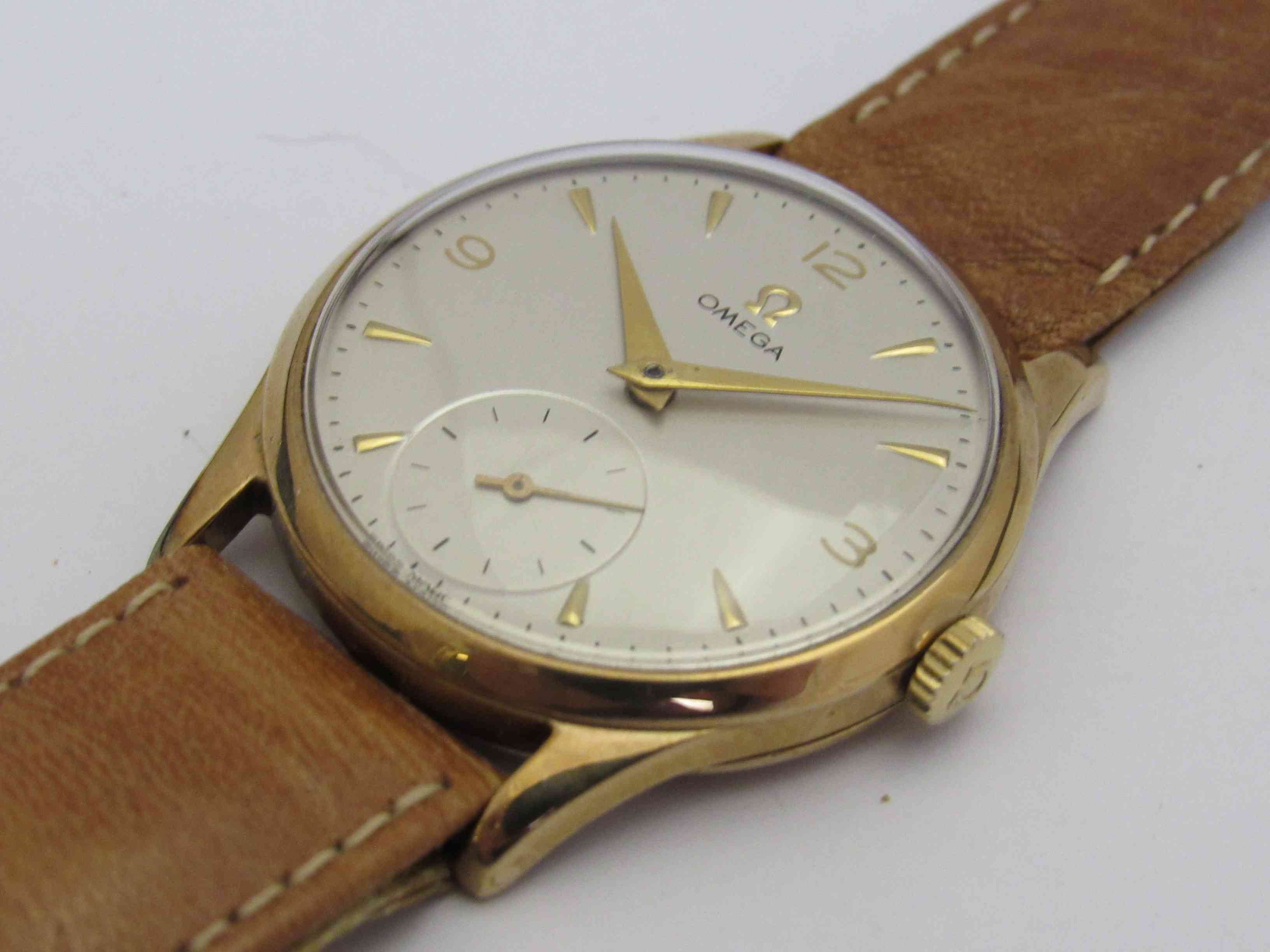 OMEGA: a manual wind gent's 9ct gold wristwatch, silvered dial with subsidiary seconds,