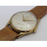 OMEGA: a manual wind gent's 9ct gold wristwatch, silvered dial with subsidiary seconds,