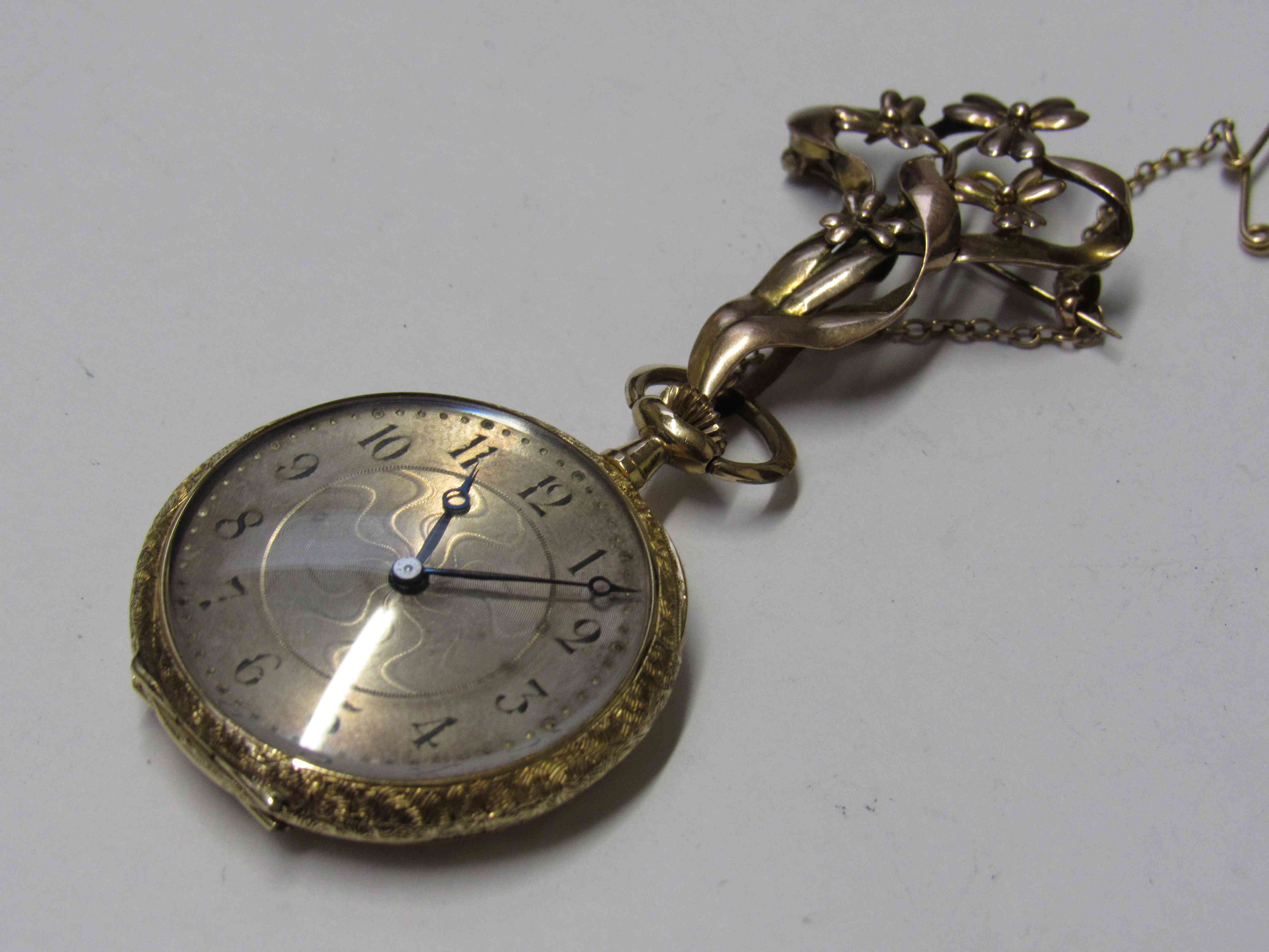 An early 20th Century 18K Continental fob watch with engraved case hung with 9ct gold brooch of