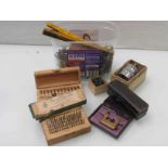 A box of watchmaker's tools including roller sinks, rules,