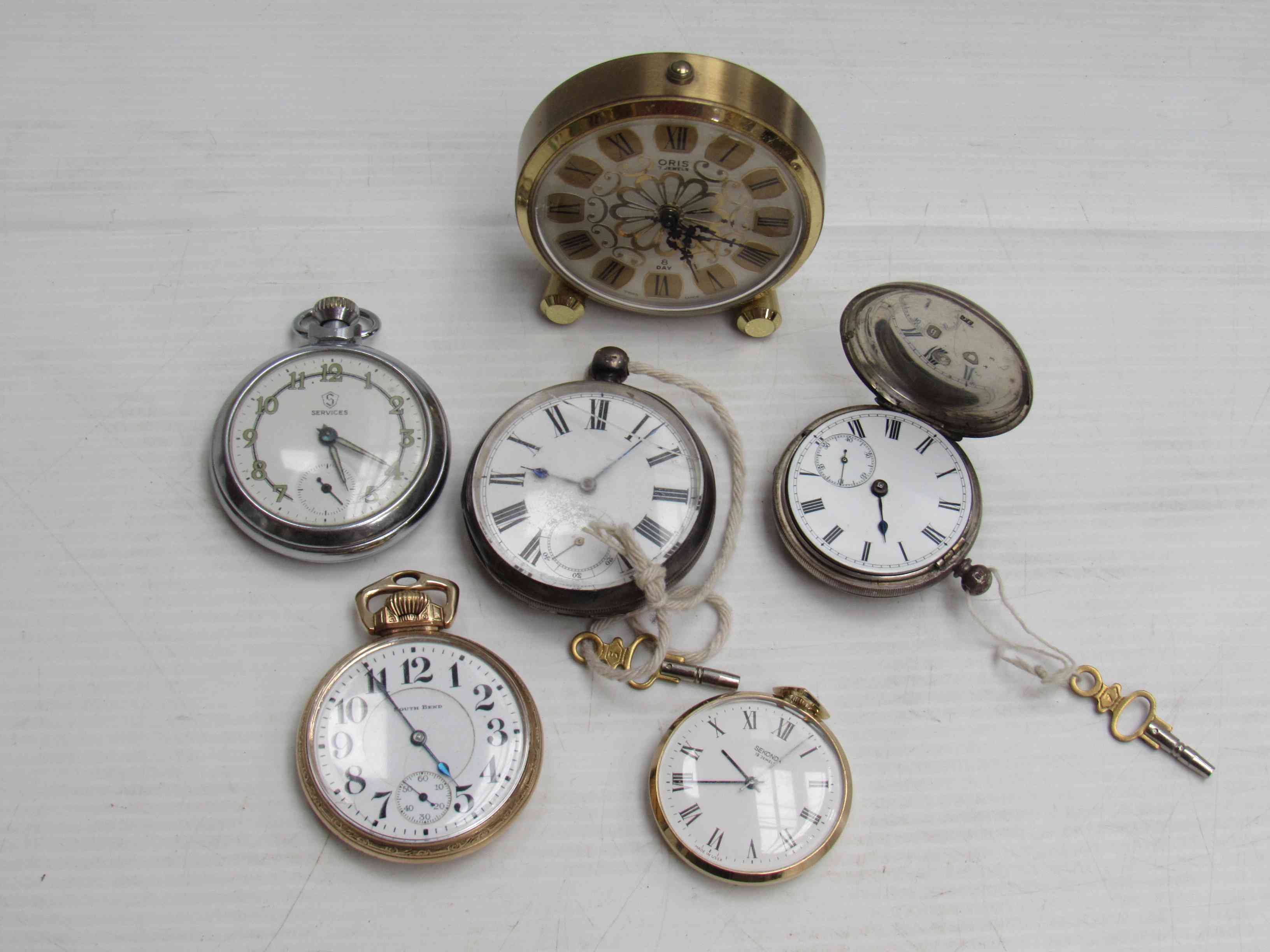 An Oris 8-day desk timepiece and five pocket watches including two silver examples