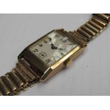 A 9ct gold gent's rectangular wristwatch with silvered Arabic dial and subsidiary seconds,