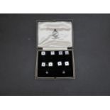 A cased set of 9ct white gold and mother of pearl dress shirt buttons,