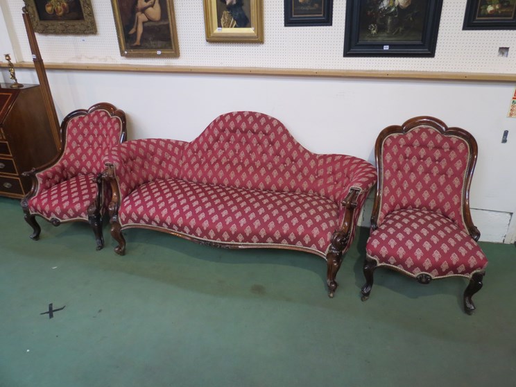 A Victorian rosewood framed sofa and two matching armchairs