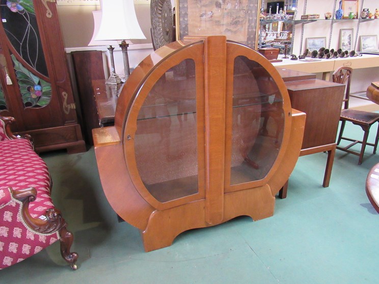 An Art Deco light mahogany floor-standing virtical circular two-door display cabinet with original