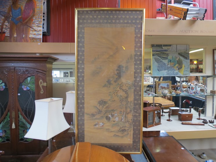 A large Oriental silk work panel depicting figures in mountainous setting, gilt framed and glazed,