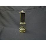 A Clanny miner's lamp, all brass with six continuous bars and side lock,