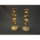 A pair of gilt metal cherub candlesticks,