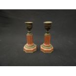 A pair of red marble and ormolu candlesticks,