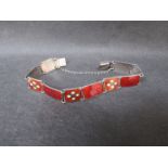 A Norwegian sterling and red enamel panel bracelet.