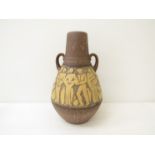 A West German twin handled floor vase, relief moulded with figures at market.