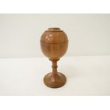 A turned wooden goblet with lid, silver mount to top. 19.
