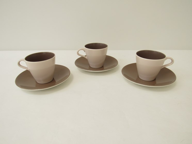 Five Poole Pottery twintone design cups and saucers designed by Robert Jefferson