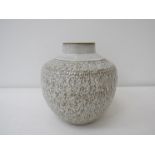 A large studio pottery stoneware vase with cream glaze over a textured body.