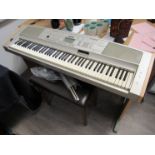 A Yamaha "Portable Grand" piano DGX500 with stand and stool