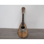 An early 20th Century round-back mandolin with mother of pearl and strung inlay a/f,