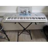 A Casio WK-3000 keyboard with stand,