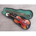 An early to mid 20th Century full size (4/4) violin, 59cm in length, cased with three bows,