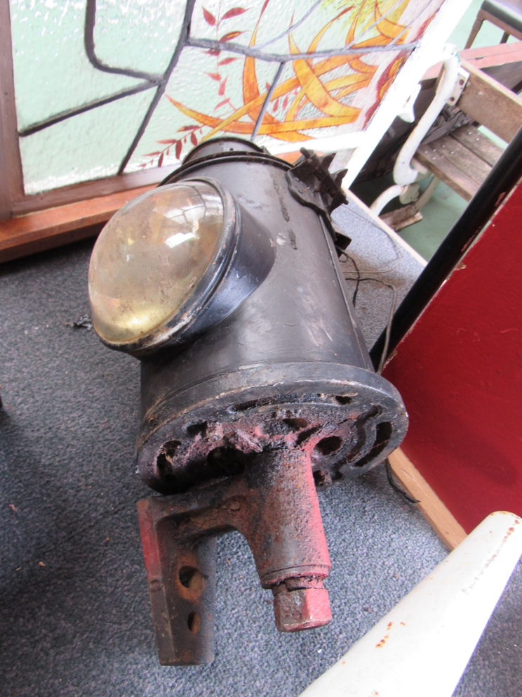 A black painted railway signal post lamp case