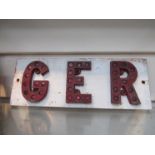 Three roadside reflective letters GER attached to wood board