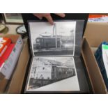 A box containing black and white photos of Woodhead Electrics