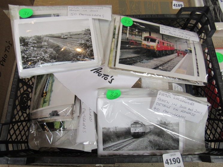 A box containing mixed black and white and colour photographs of locomotives
